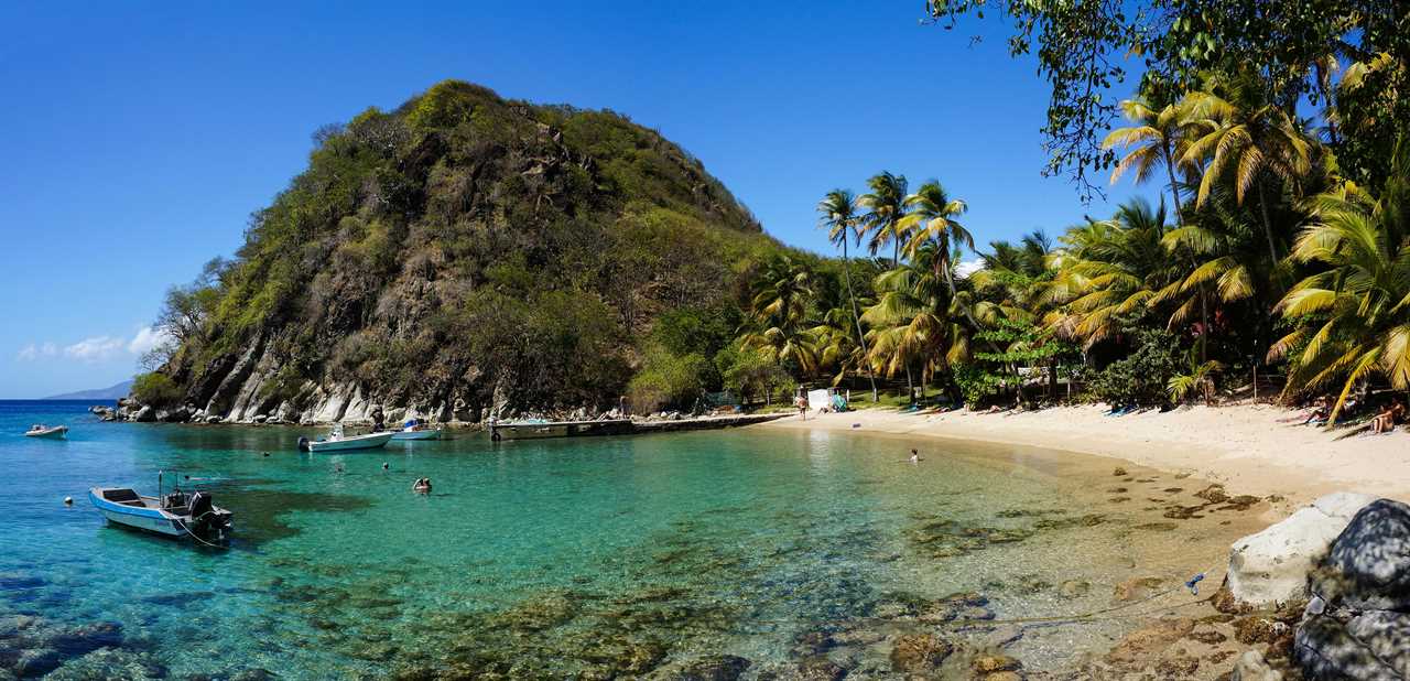 The location of DI Goodman’s shack is one of the most beautiful spots on the island, with its miles of unspoilt beach fringed by palm trees