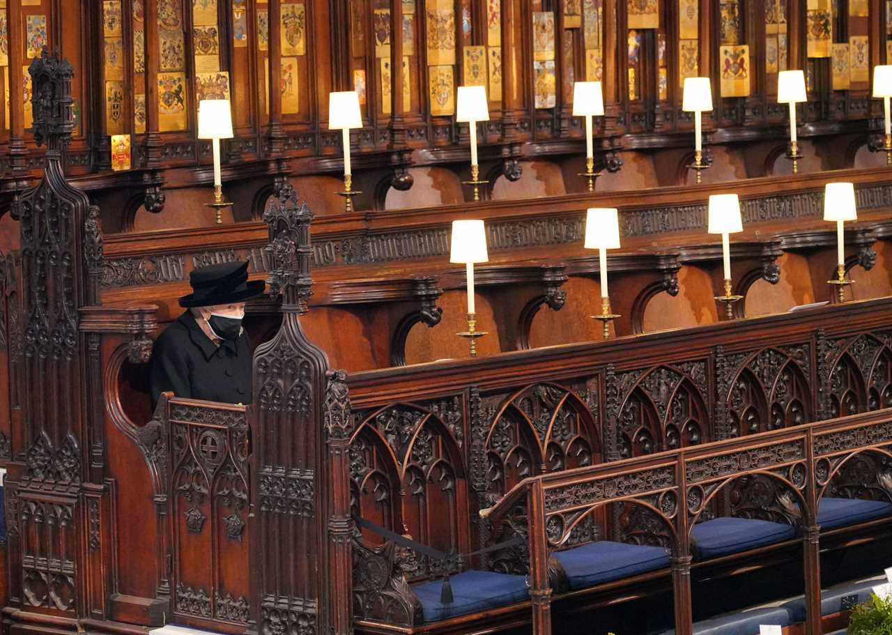 The Queen sitting alone as she looks at her husband's coffin