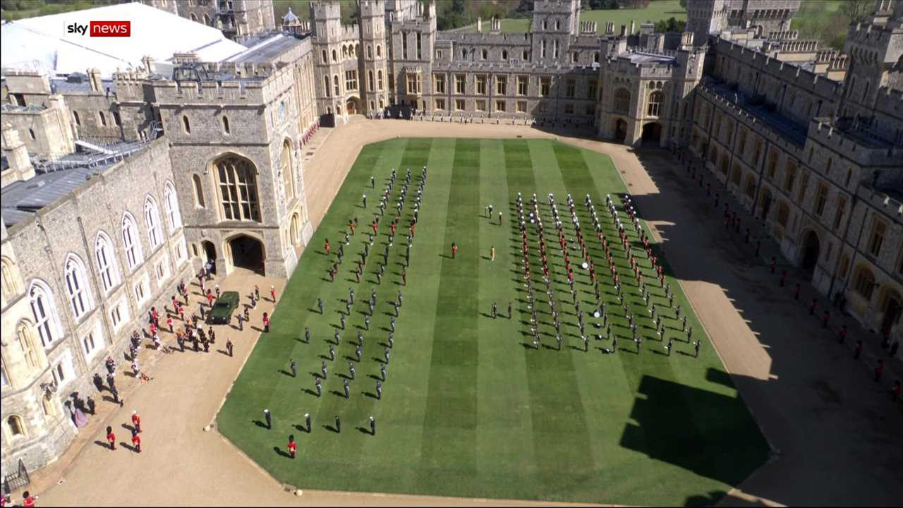 A band plays I Vow to Thee my Country as the Land Rover is taken to the State Entrance