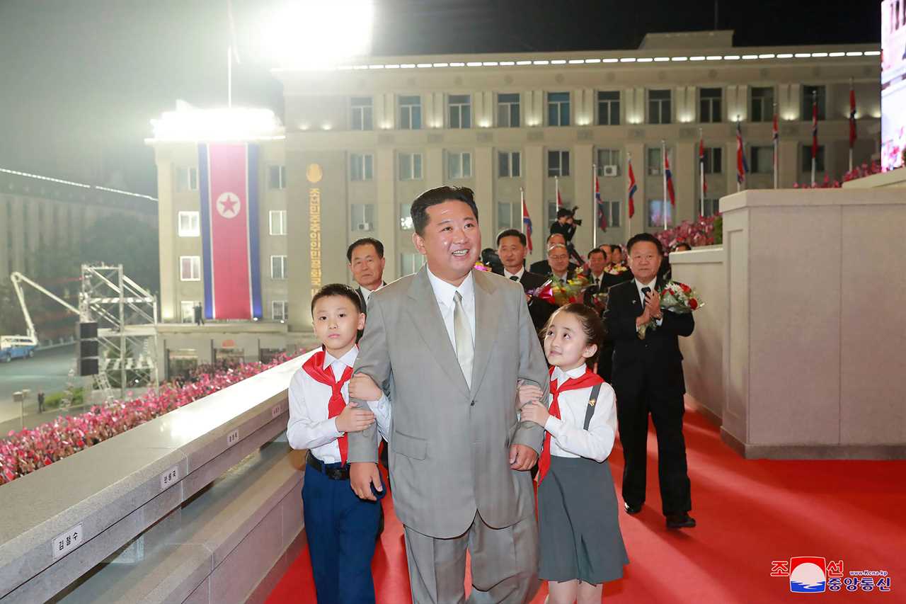 North Korea tyrant Kim Kong-un being hugged by adoring children