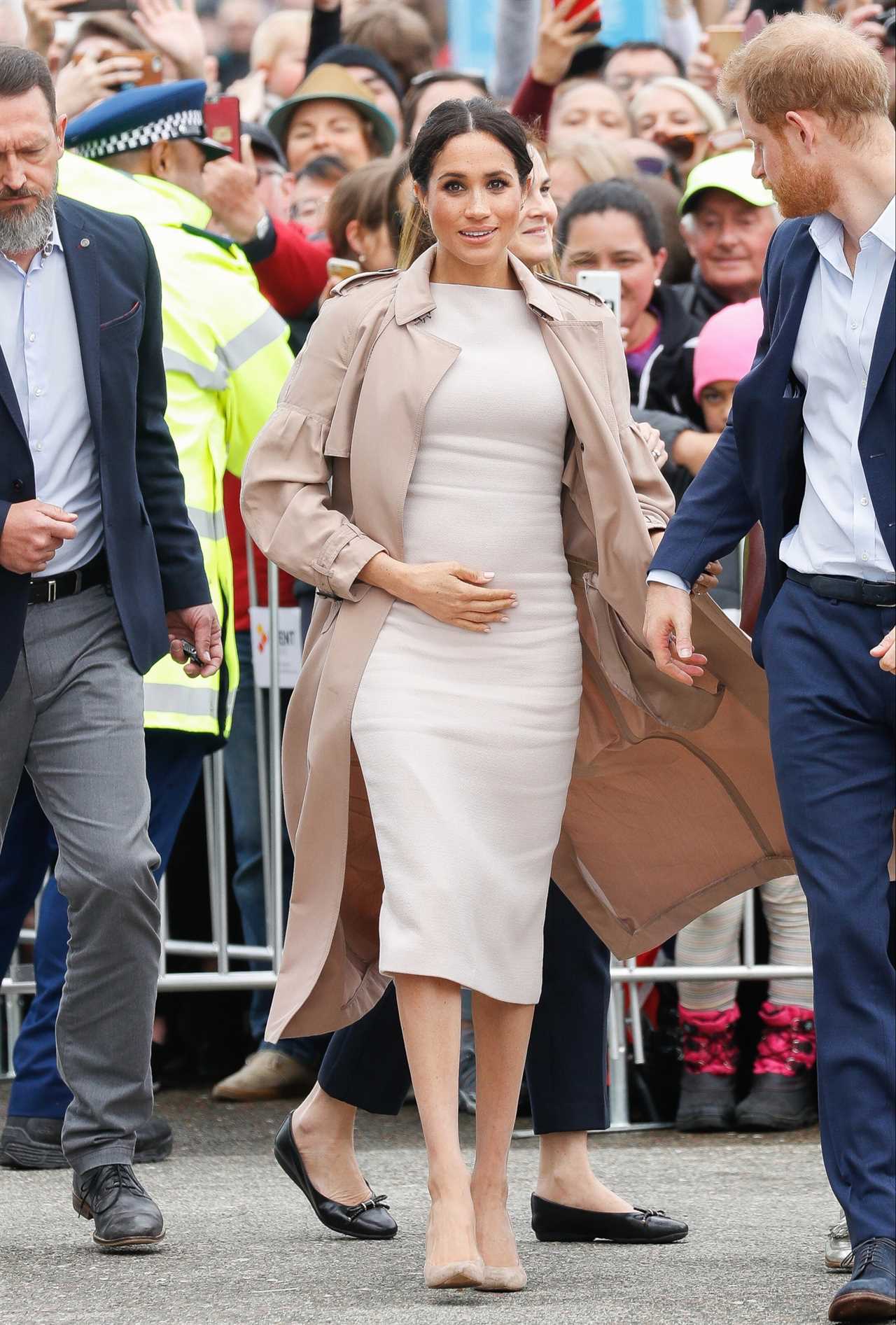 Meghan paired this £2,400 Burberry coat with a £2,000 cream Brandon Maxwell dress