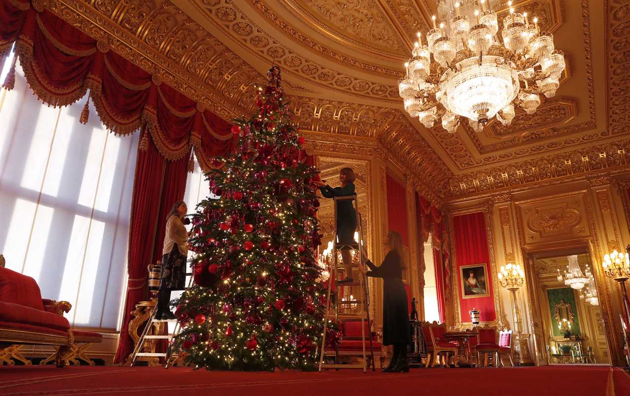 Staff had to climb ladders to get the red and gold decorations to the higher branches