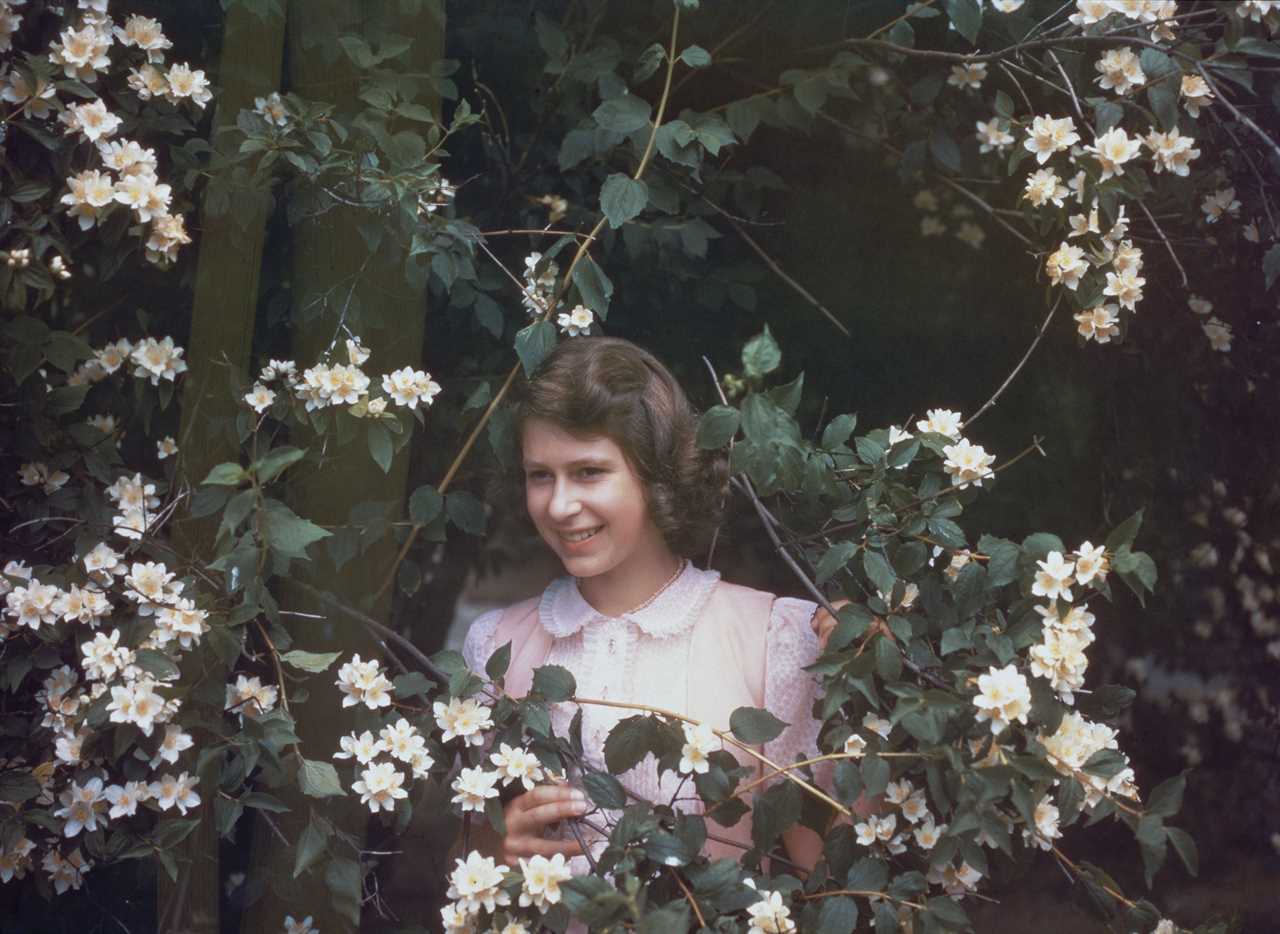 Surrounded by flowers on July 8, 1941, at the age of 15, at Windsor Castle in Berkshire