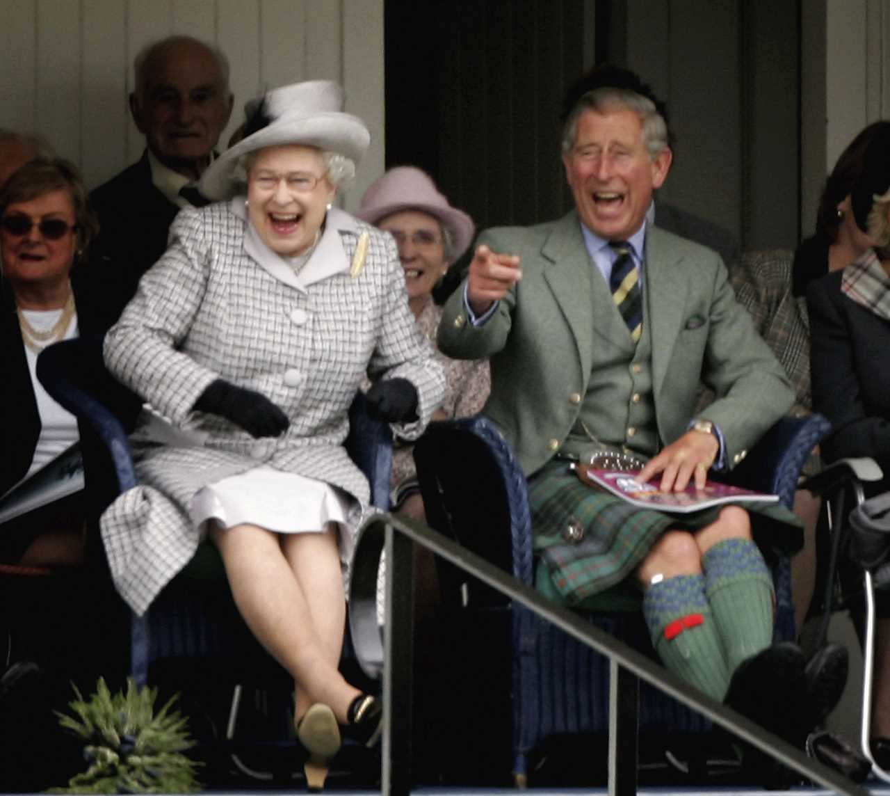 The Queen laughing with Prince Charles as they watch competitors during the Braemar Gathering at the Princess Royal and Duke of Fife Memorial Park on September 2, 2006 in Braemar, Scotland