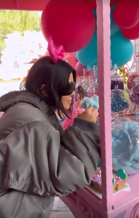 Kourtney Kardashian picked at sweet treats and wore a big jacket in a new video