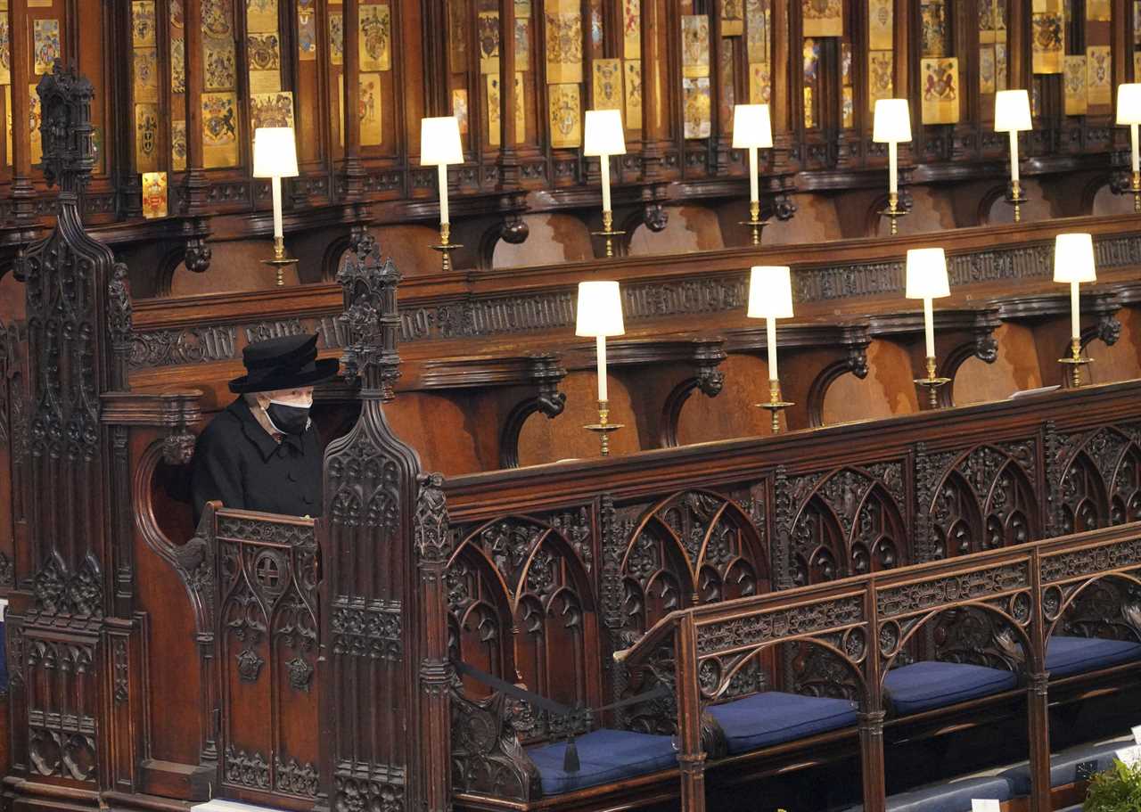 The Queen pictured sitting alone at Philip's funeral last April