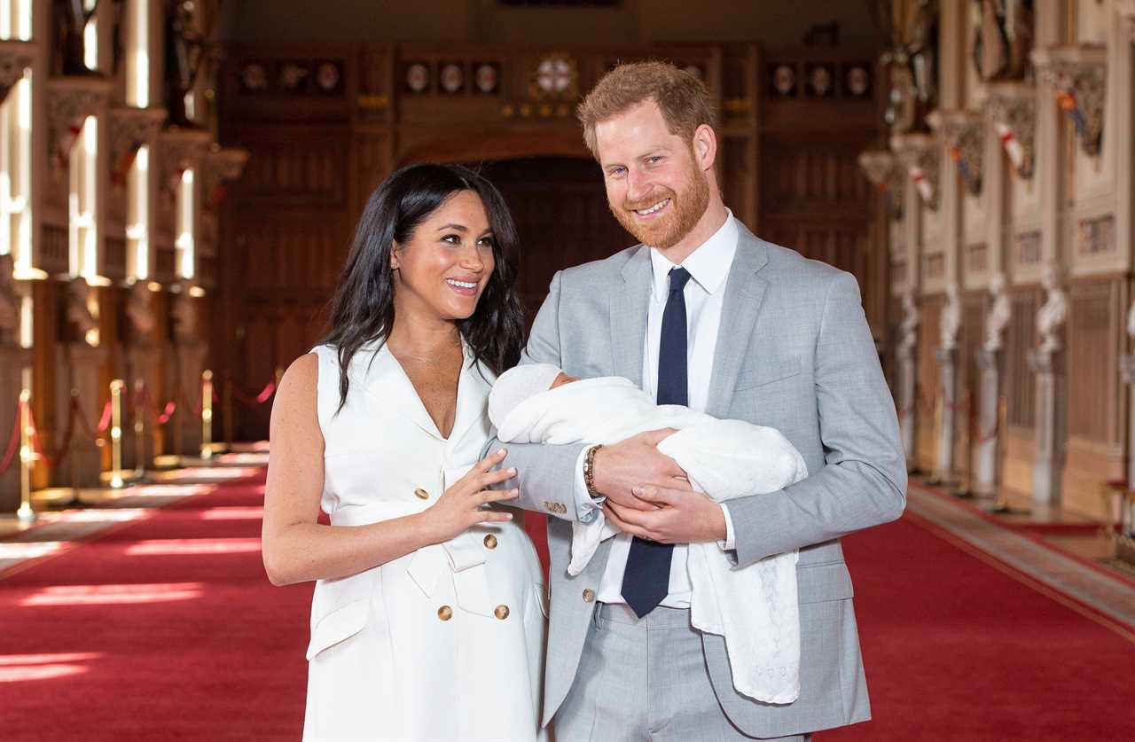 Meghan and Harry pose with their newborn son pose with their newborn son  during a photocall in St George’s Hall at Windsor Castle shortly after his birth