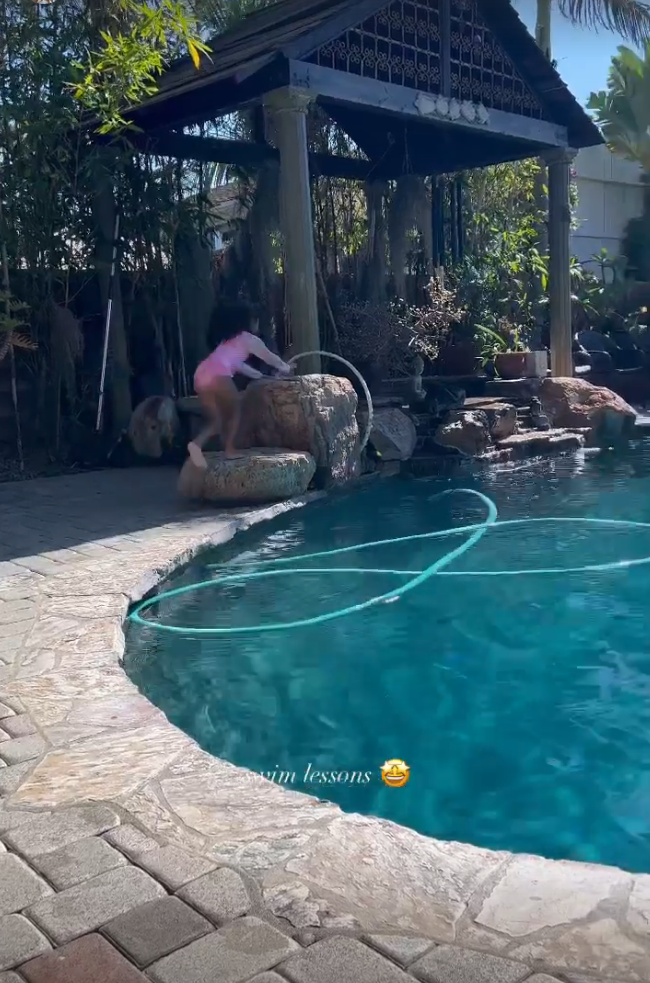 She shared a video of the five-year-old climbing up some rocks and jumping off them into the pool