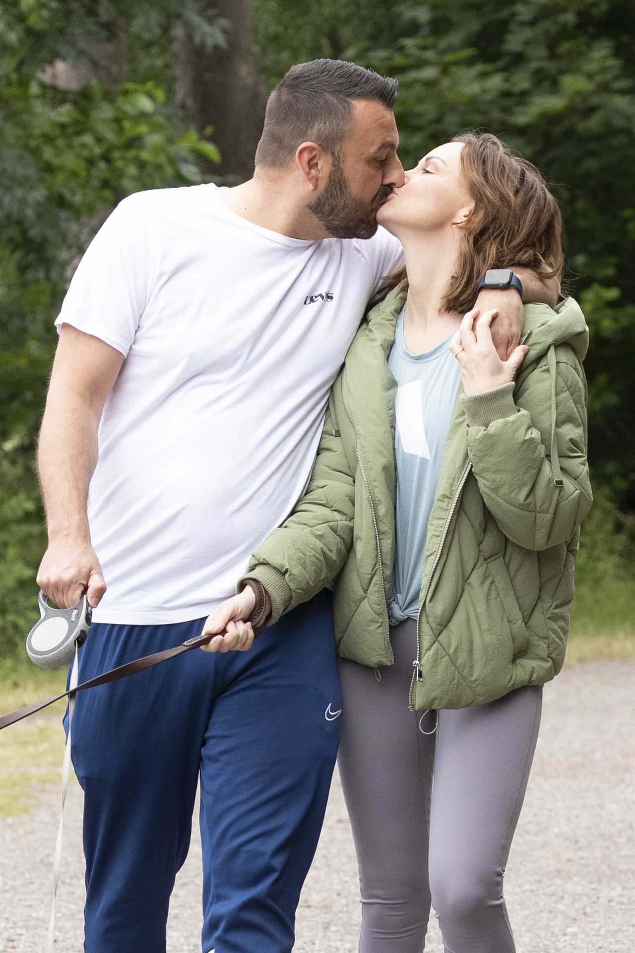 Chanelle Hayes flashes her sparkling engagement ring as she kisses fiancé Dan Bingham on dog walk