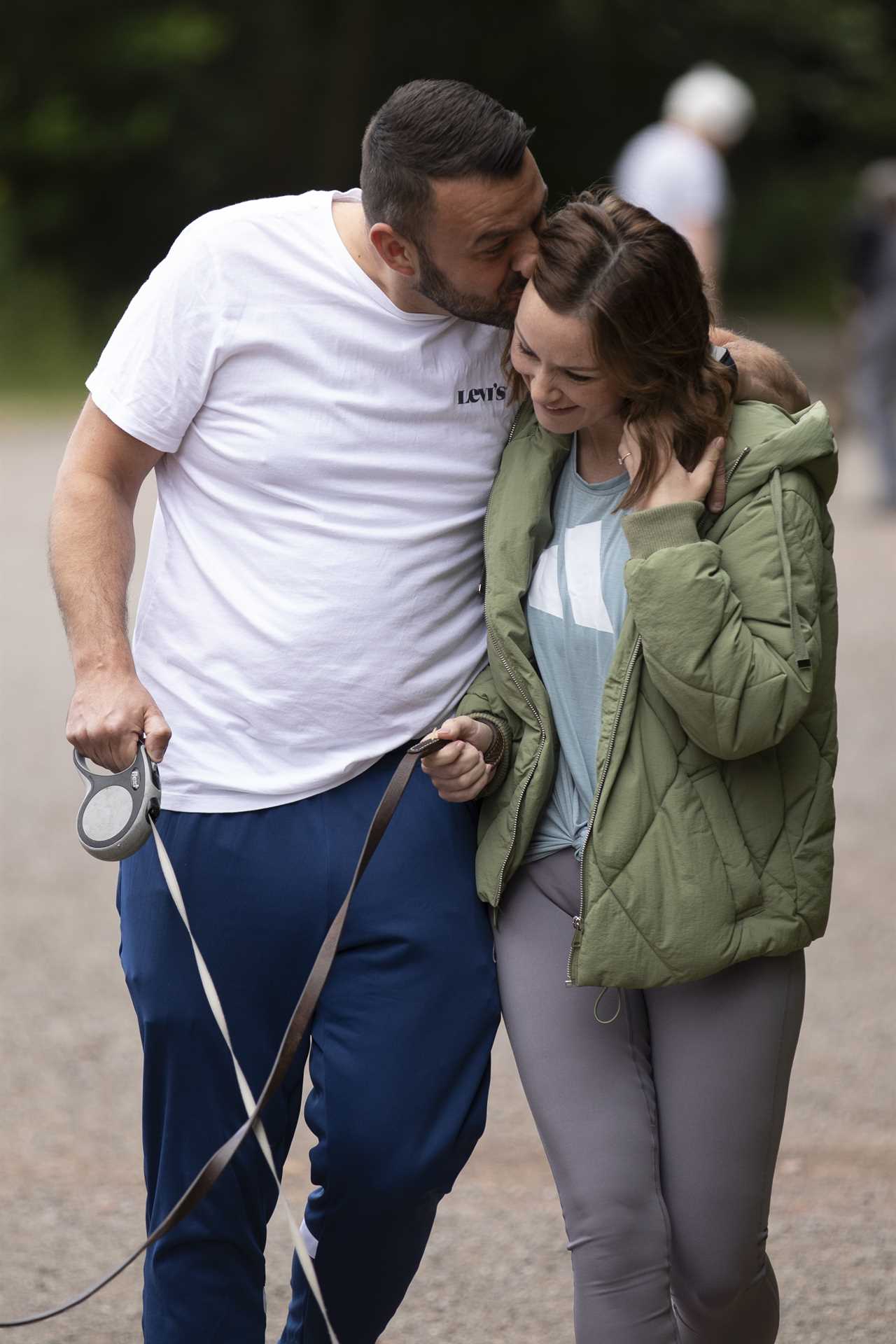 Chanelle Hayes flashes her sparkling engagement ring as she kisses fiancé Dan Bingham on dog walk