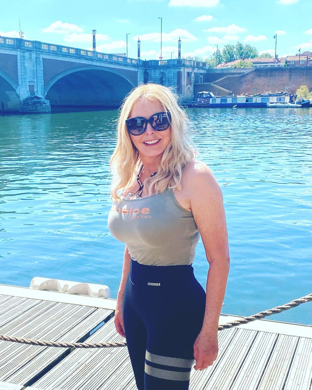 Carol Vorderman shows off her figure in tight vest top as she soaks up the sun