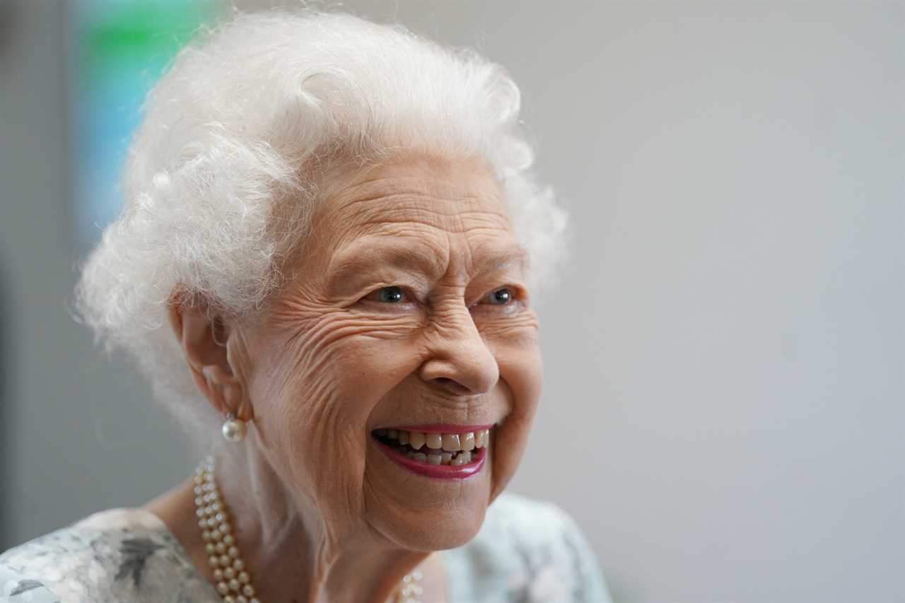 Queen, 96, beams in summer florals as she makes surprise visit to support hospice patients