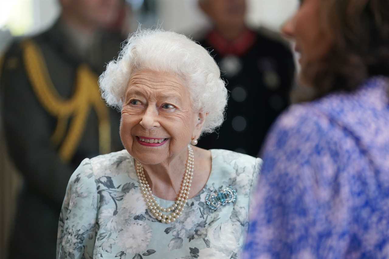 Queen, 96, beams in summer florals as she makes surprise visit to support hospice patients