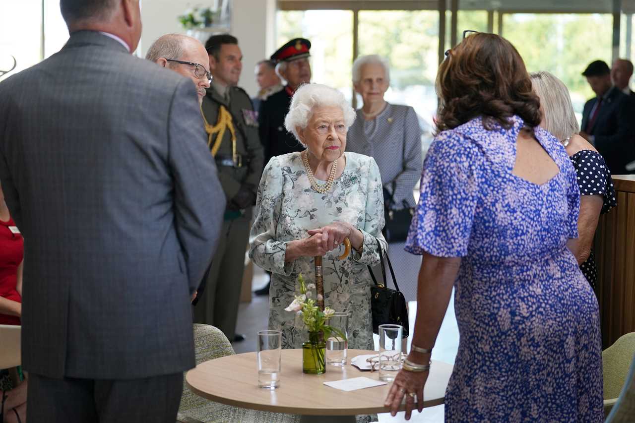 Queen, 96, beams in summer florals as she makes surprise visit to support hospice patients