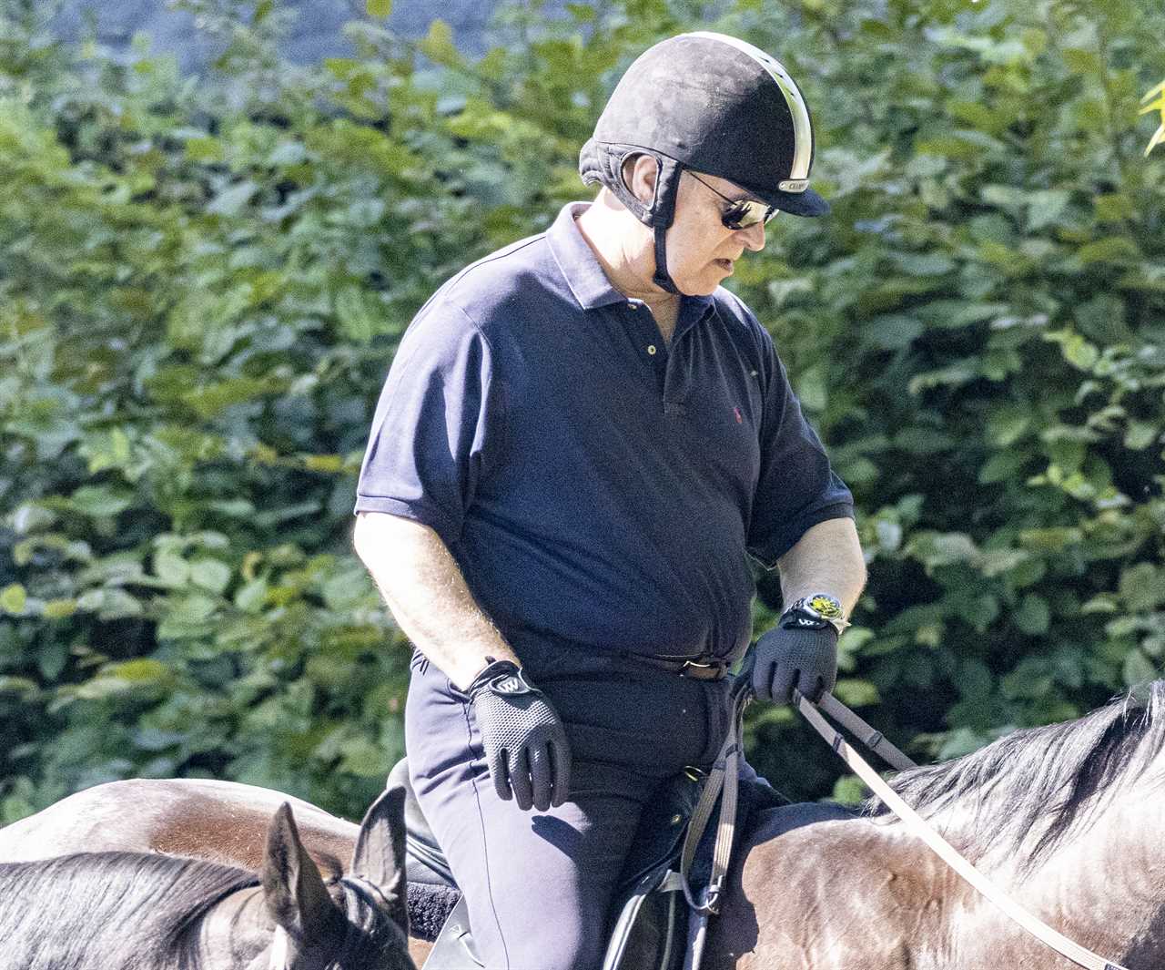 Stony-faced Prince Andrew goes riding at Windsor amid reports his car-crash interview is being turned into a movie