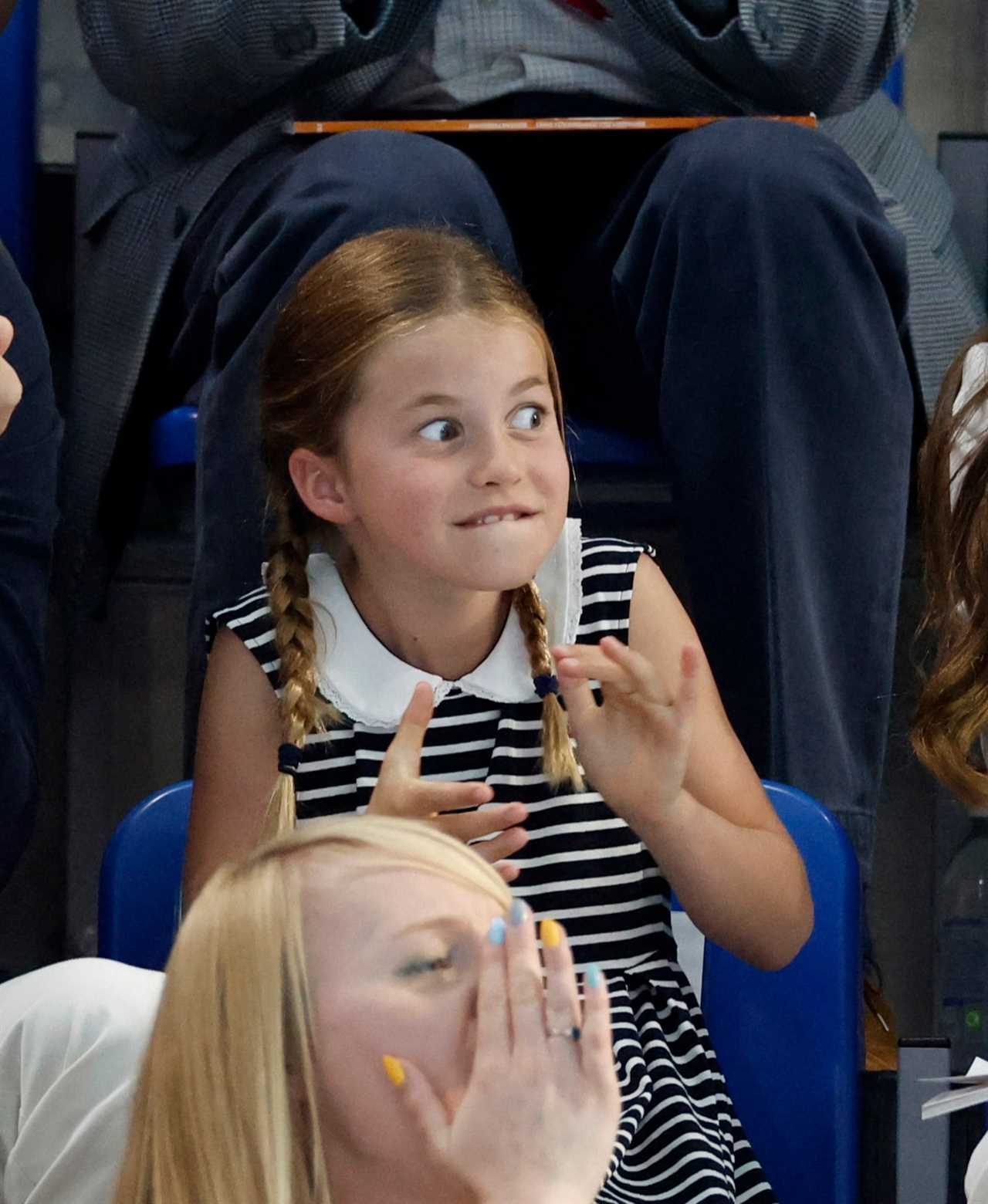 Princess Charlotte, 8, grins as she watches Commonwealth Games swimming race with mum Kate Middleton and Prince William