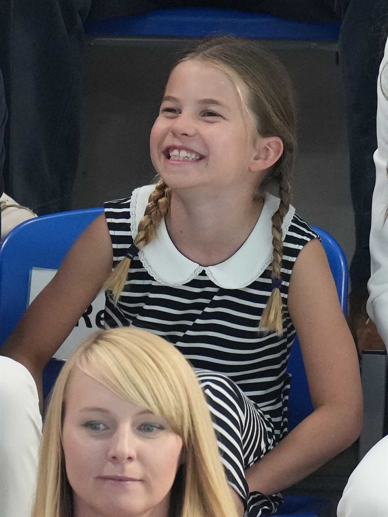 Princess Charlotte, 8, grins as she watches Commonwealth Games swimming race with mum Kate Middleton and Prince William