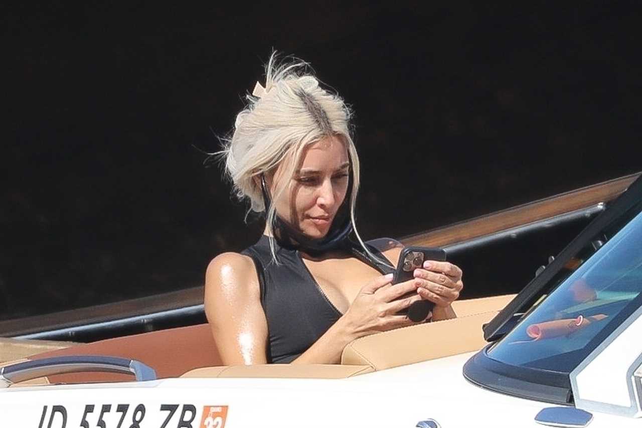 Kim Kardashian spills out of plunging top & shows off real skin with natural wrinkles as fans say she’s back with Kanye