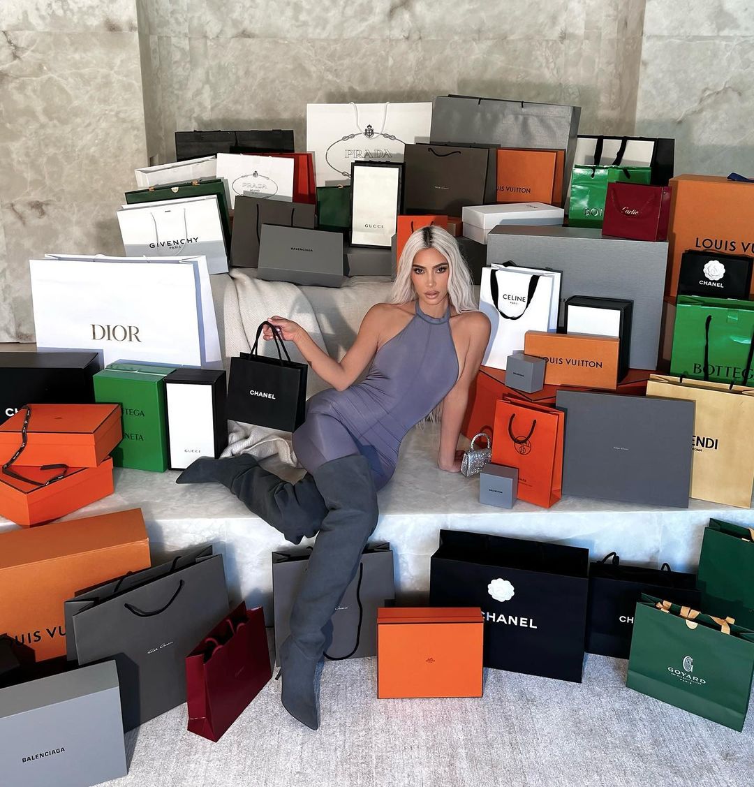 Kardashian fans slam Kim as ‘tasteless’ for posing with a mountain of designer bags after outrage for ‘flaunting wealth’