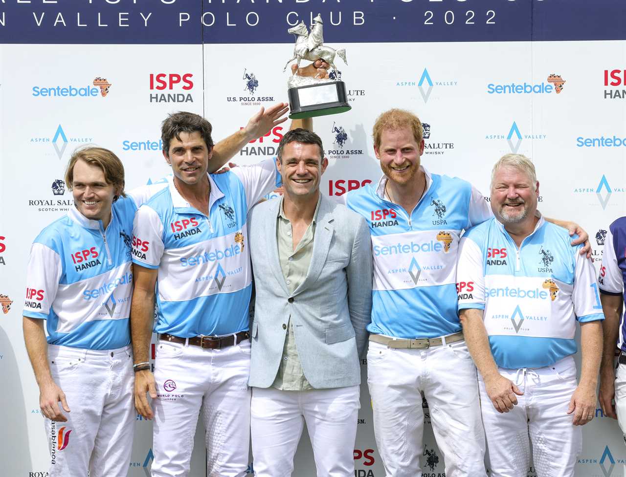 Jubilant Prince Harry lifts trophy after winning polo title with team in charity tournament where he scored hattrick