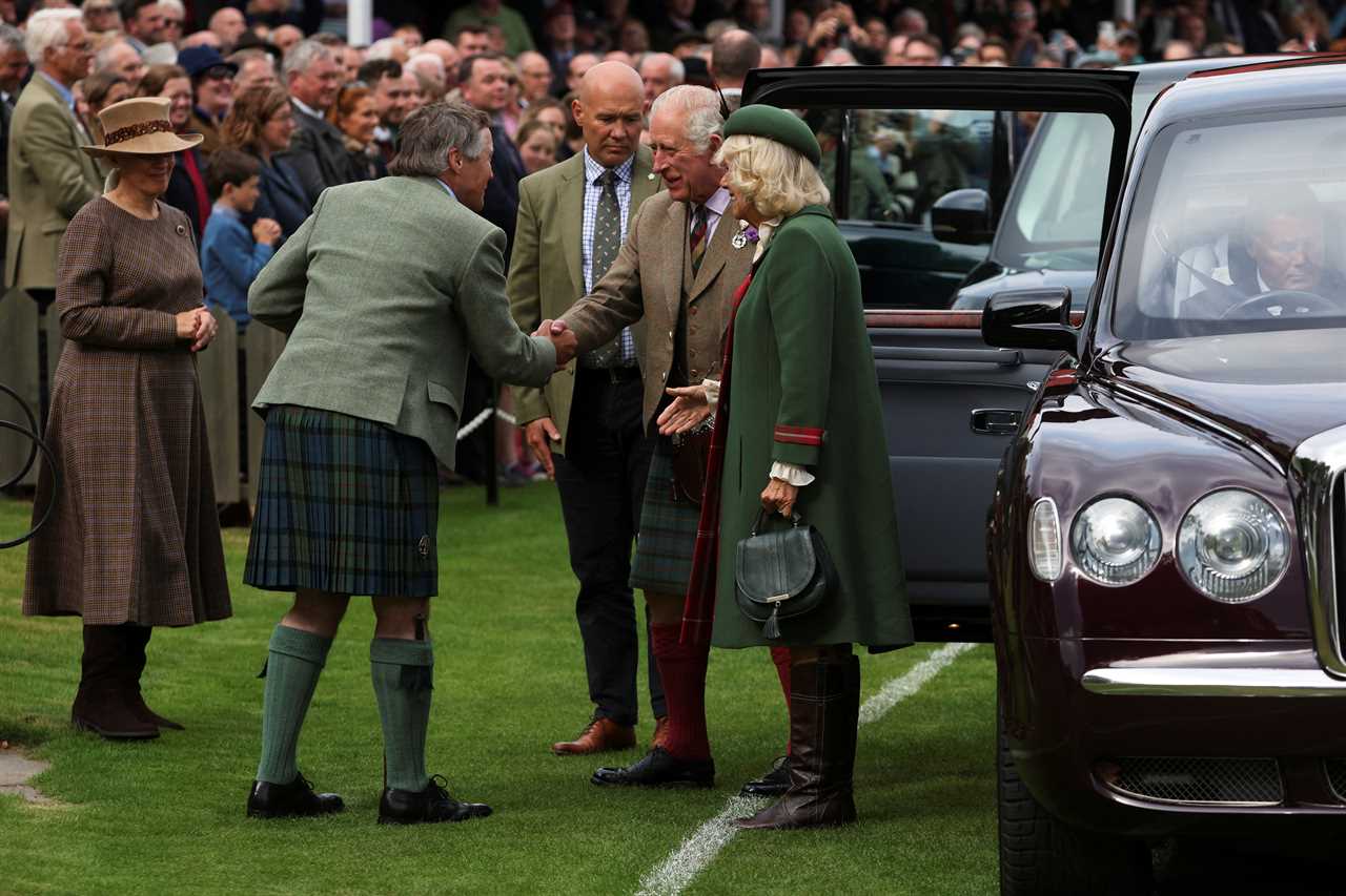 Prince Charles enjoys Highland games as he stands in for the Queen, 96, at one of her favourite events