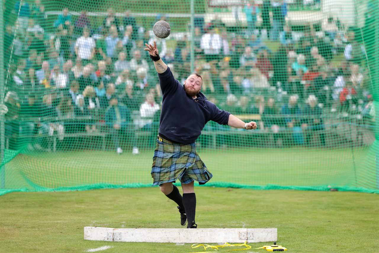 Prince Charles enjoys Highland games as he stands in for the Queen, 96, at one of her favourite events