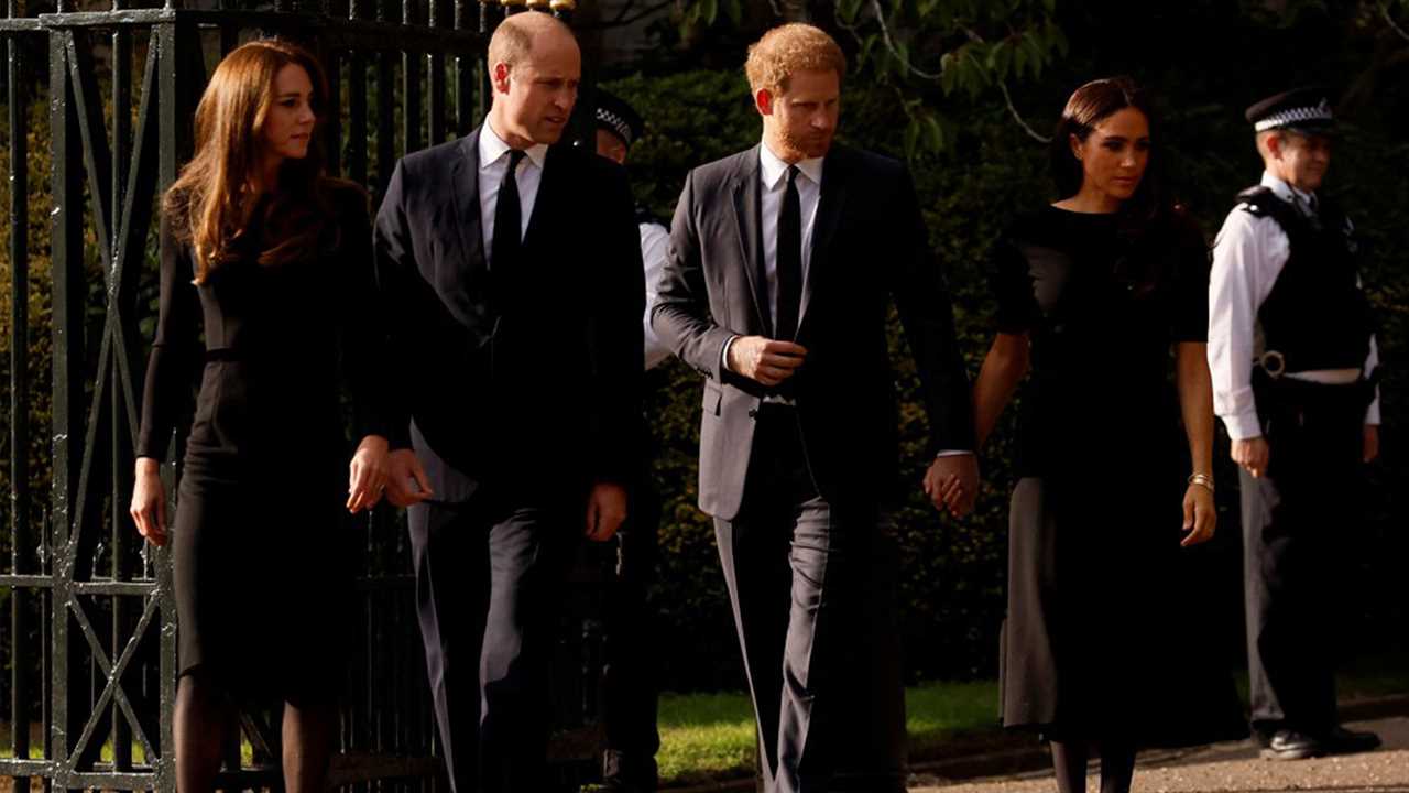 Sweet moment Meghan Markle comforts Prince Harry as he looks at floral tributes for the Queen