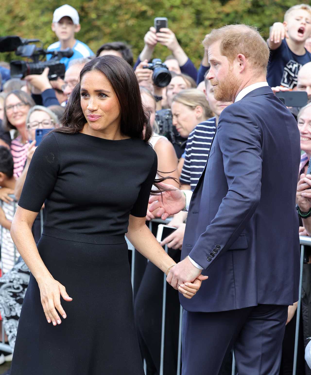 Watch awkward moment Meghan Markle is snubbed by royal fan who refuses to shake her hand at Fab Four’s walkabout