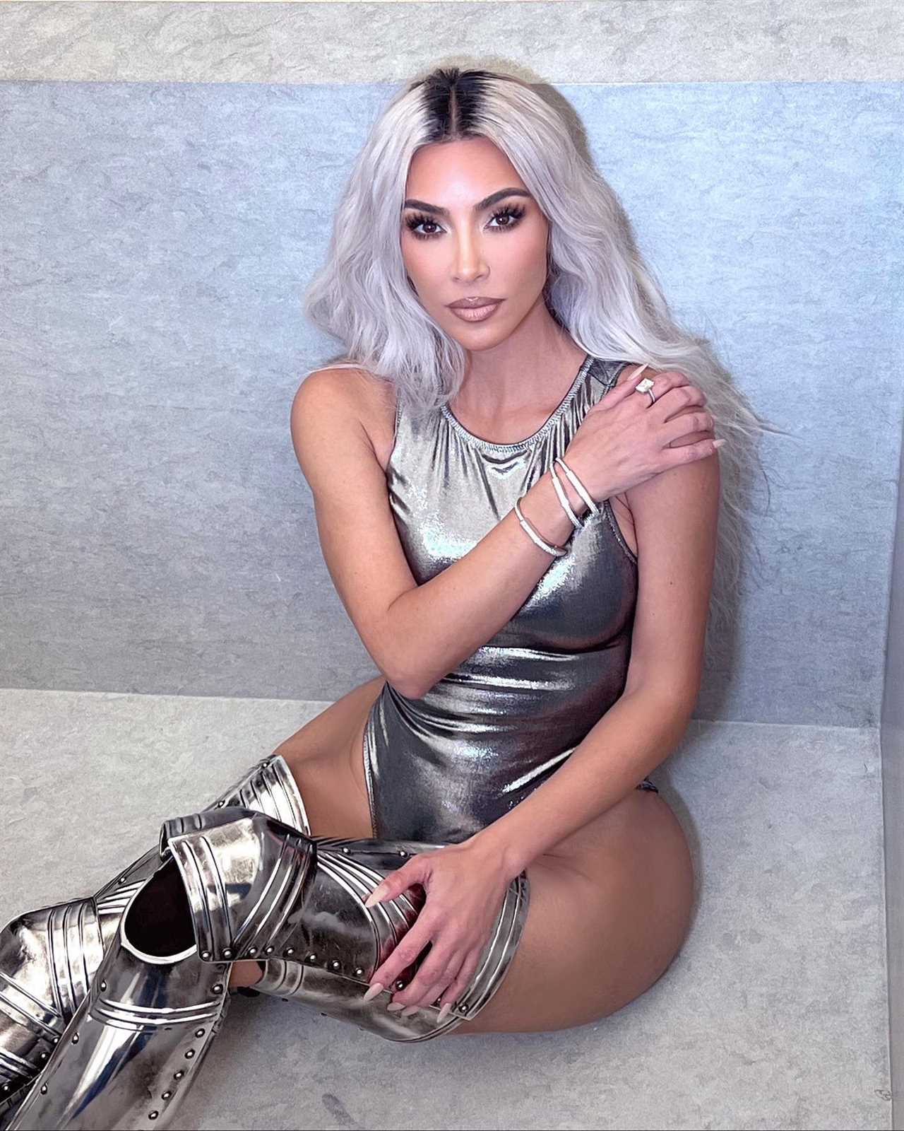 Kim Kardashian poses in just a silver bodysuit & thigh-high boots in sexy new photos after her dramatic weight loss