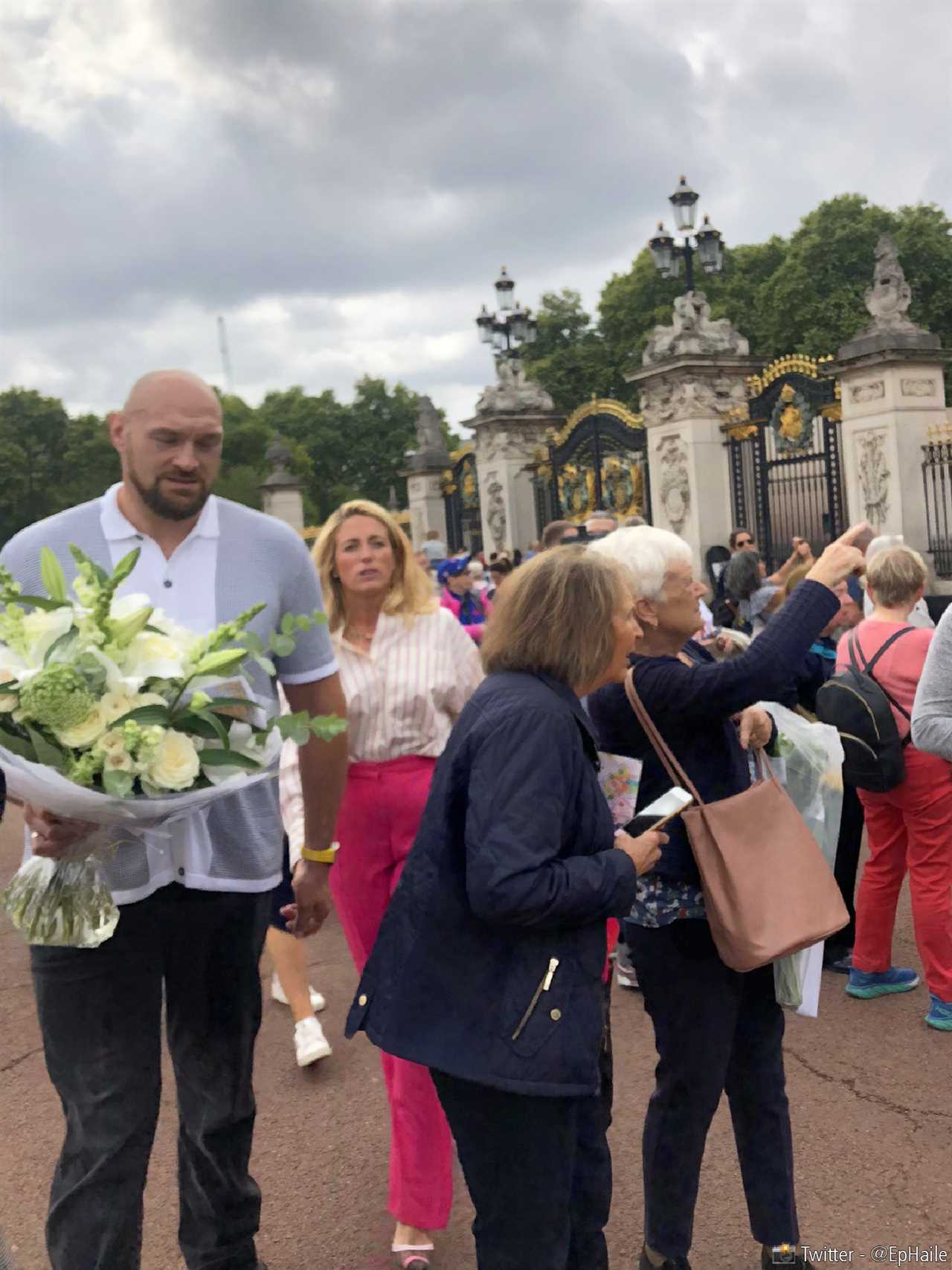 Tyson Fury and wife Paris in sweet tribute to The Queen as they lay flowers at the gates of Buckingham Palace