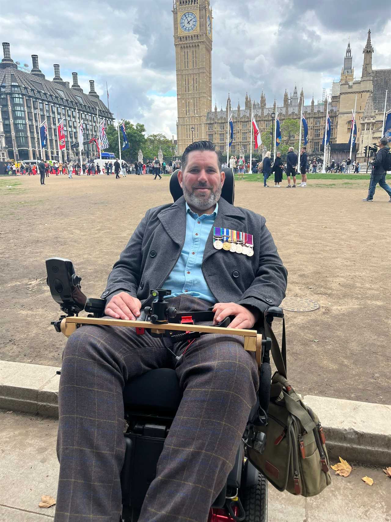 Incredible moment wheelchair-user Army hero struggles to his feet to salute the Queen one last time