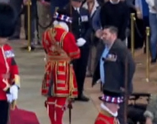 Incredible moment wheelchair-user Army hero struggles to his feet to salute the Queen one last time