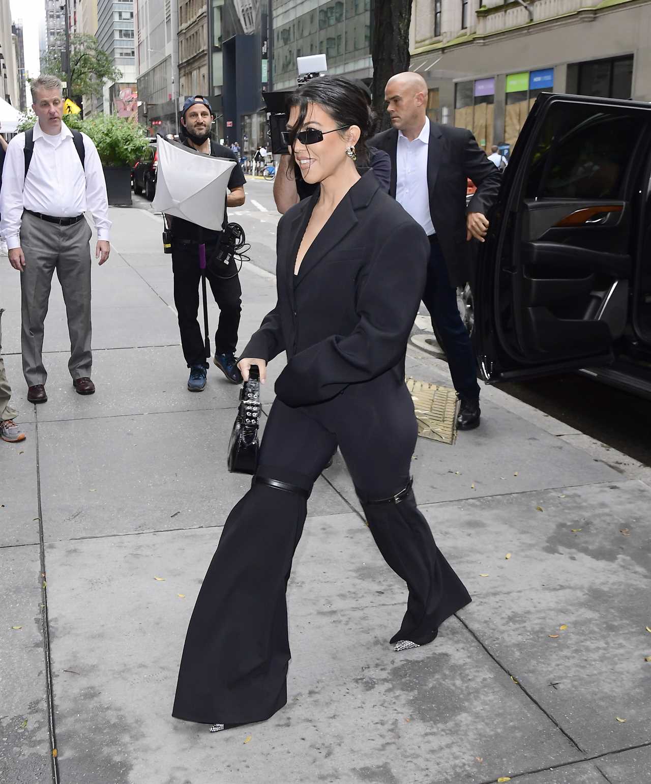 Kourtney Kardashian shows off slim body in green jumpsuit as fans slam star for photoshop fail in ‘heavily edited’ photo