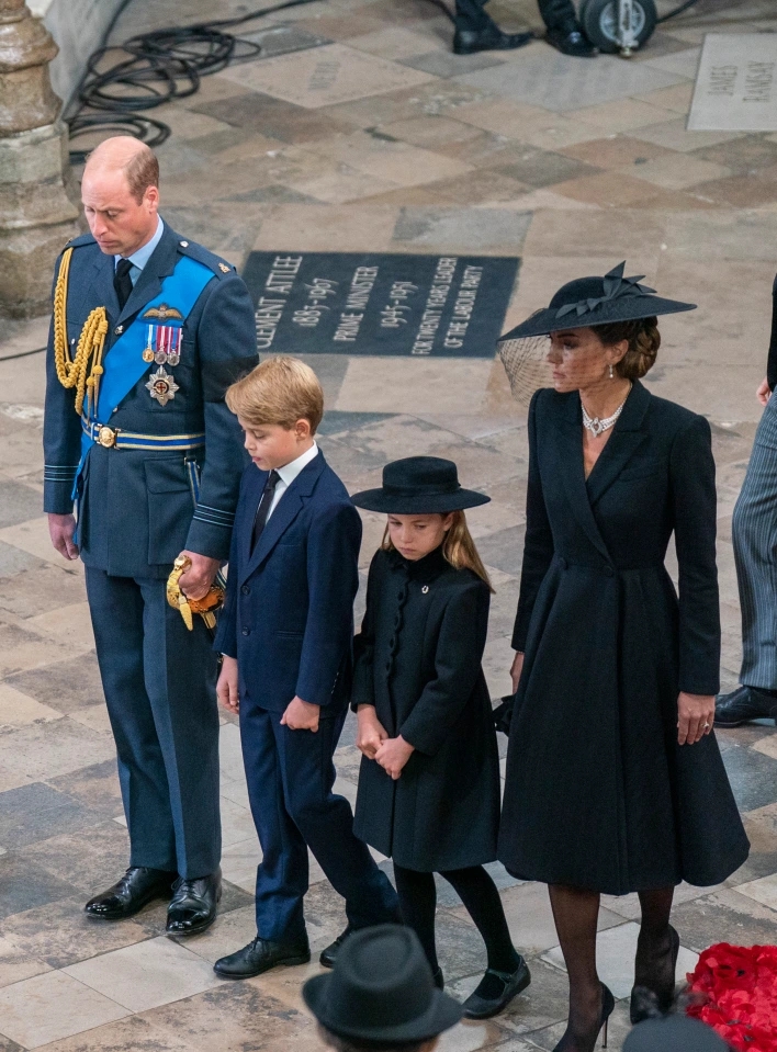 Cheeky Prince George spotted poking out his tongue as he sits next to Charlotte after Queen’s funeral procession