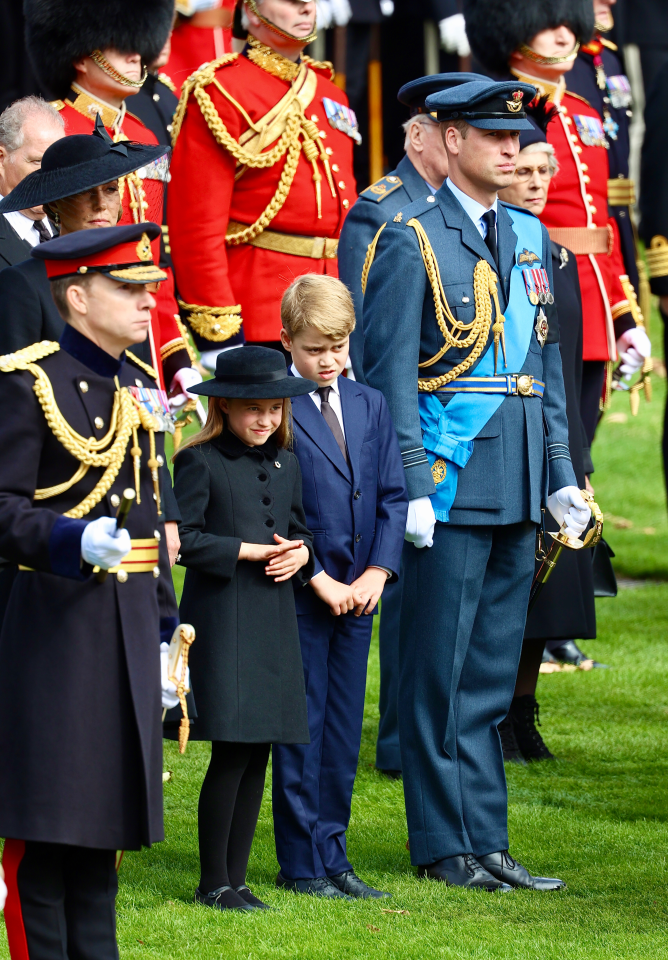 Cheeky Prince George spotted poking out his tongue as he sits next to Charlotte after Queen’s funeral procession