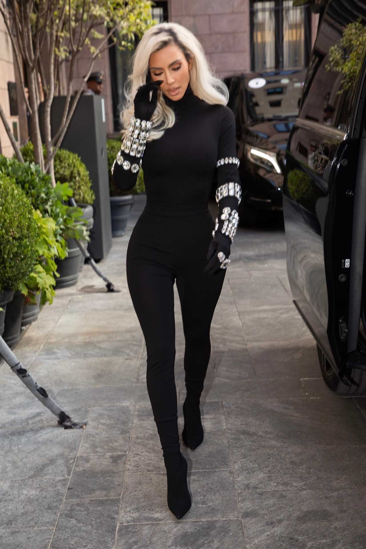 Kim Kardashian shows off her tiny waist and dramatic hair makeover as she struts in Dolce & Gabbana catsuit in Milan