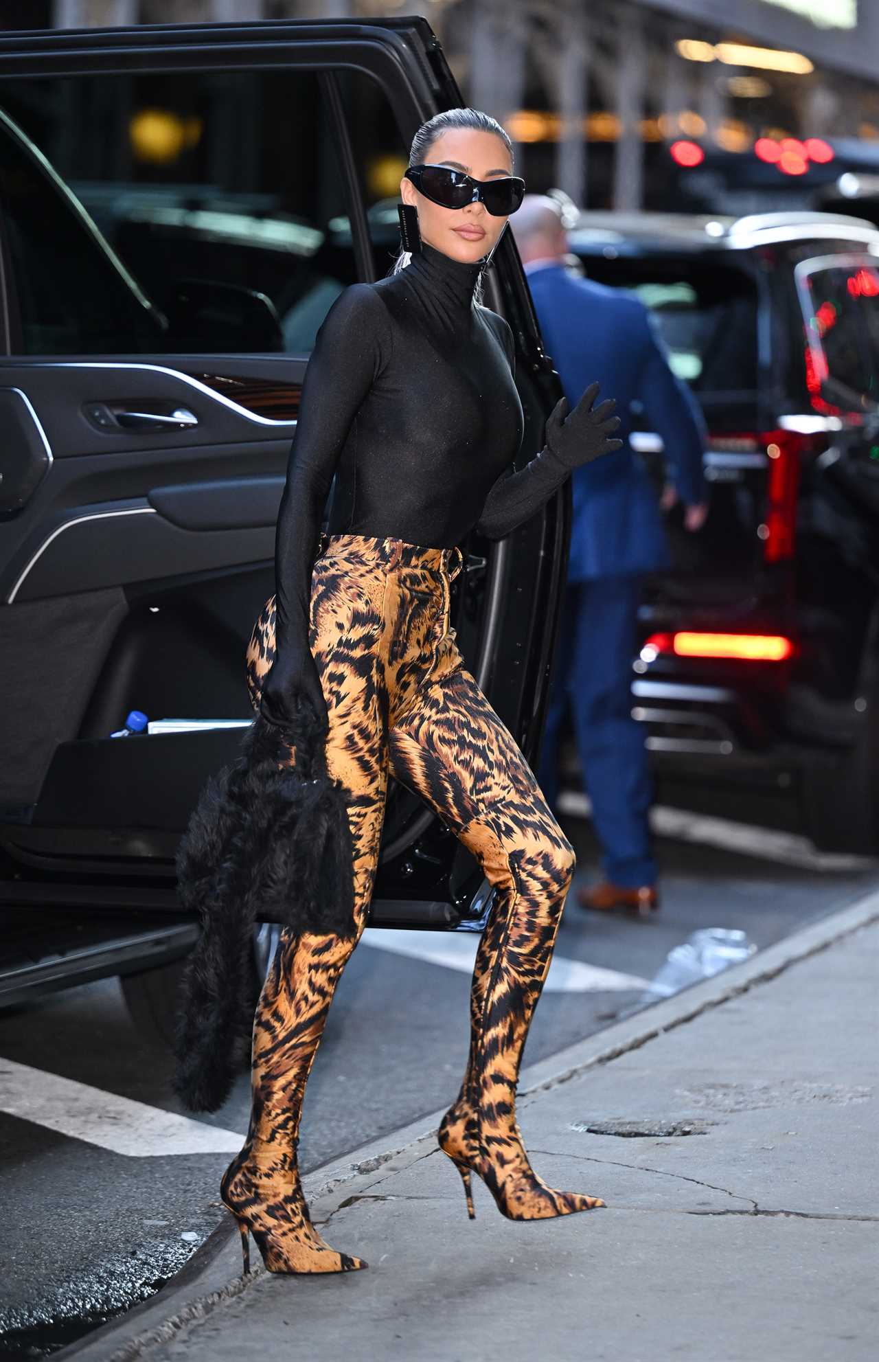 Kim Kardashian shows off her tiny waist and dramatic hair makeover as she struts in Dolce & Gabbana catsuit in Milan