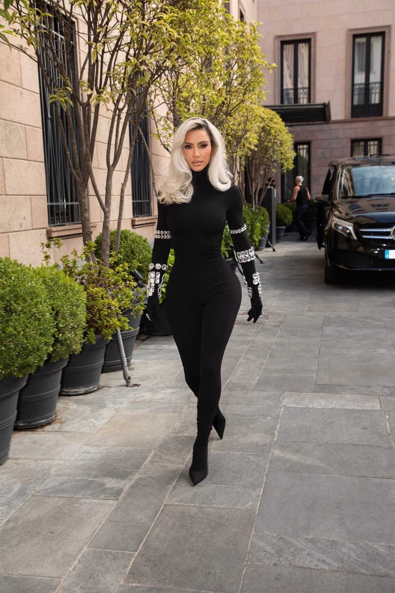 Kim Kardashian shows off her tiny waist and dramatic hair makeover as she struts in Dolce & Gabbana catsuit in Milan