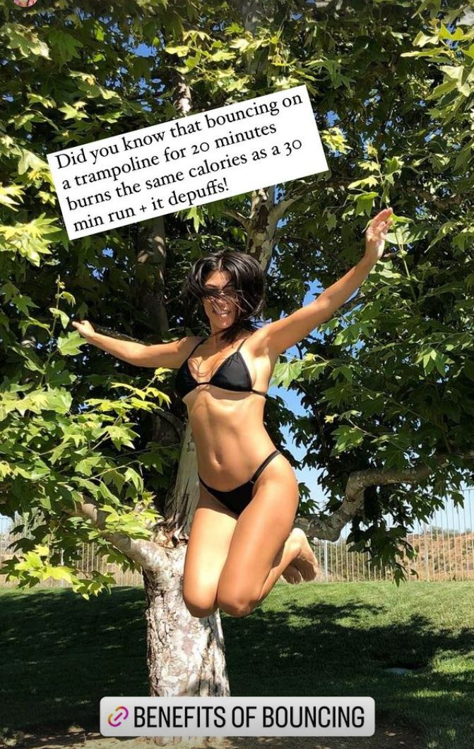 Kourtney Kardashian shows off her curves in a very tiny black bikini as she jumps up and down amid pregnancy rumors