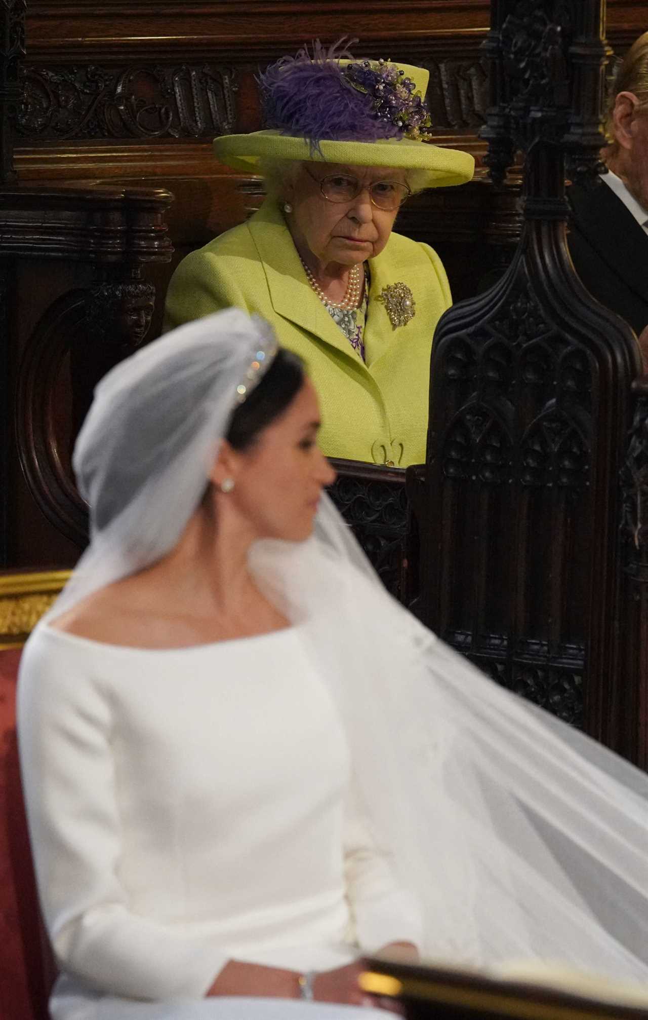 The Queen was ‘surprised’ that divorcee Meghan Markle wanted to wear a pure white wedding dress, new royal book reveals