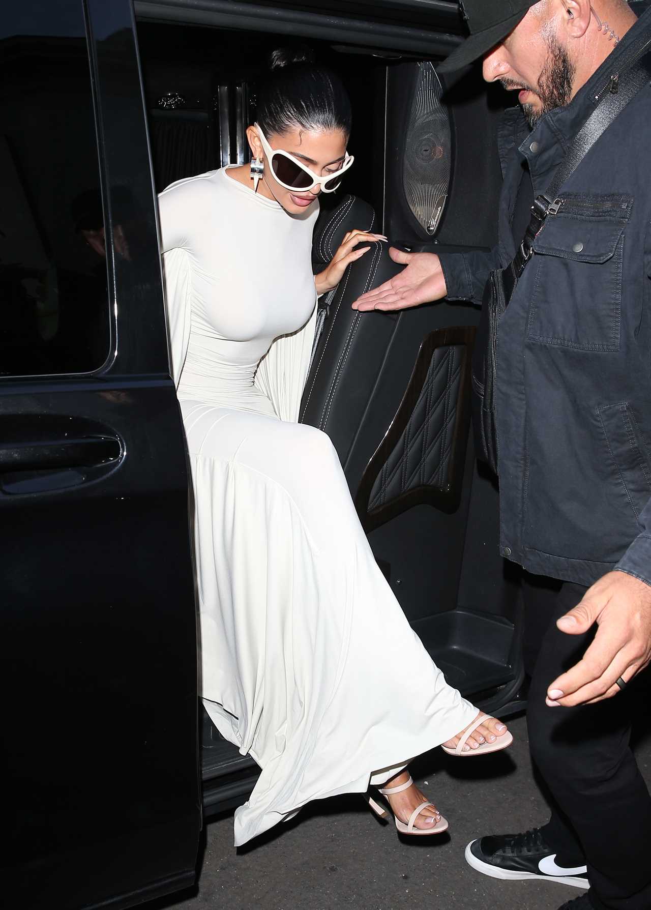 Kylie Jenner shows off her post-baby curves in skintight white dress as she arrives to Paris fashion week