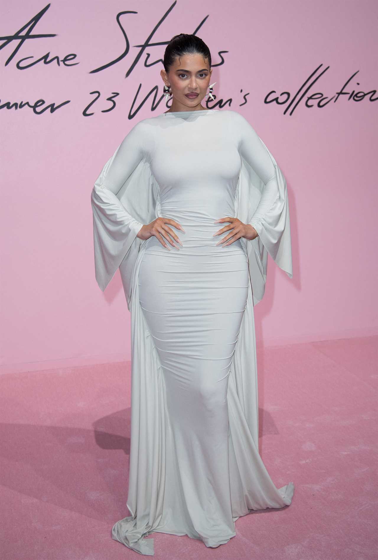 Kylie Jenner shows off her post-baby curves in skintight white dress as she arrives to Paris fashion week