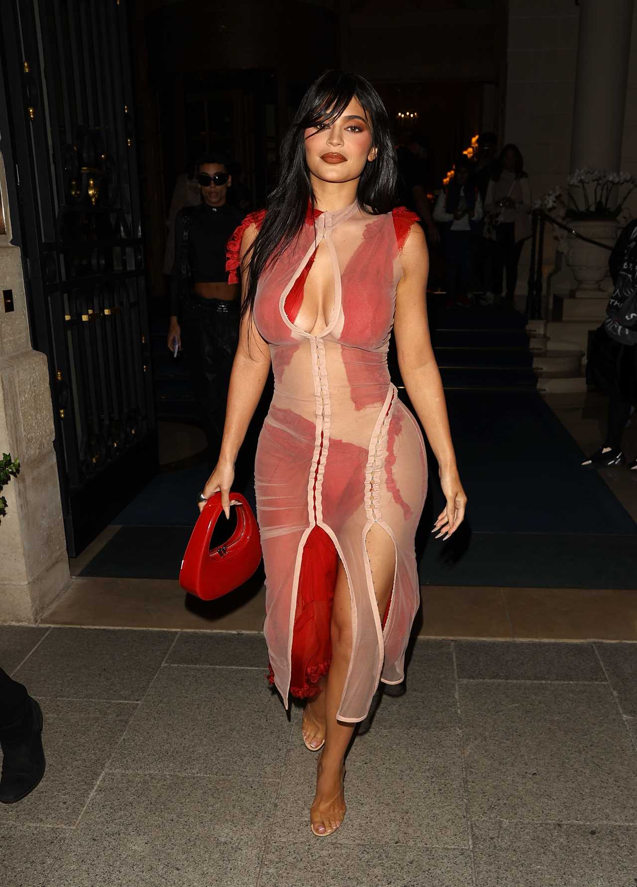 Kylie Jenner shows off her real hair without wigs & extensions as she goes pantless in a white bodysuit & coat in Paris