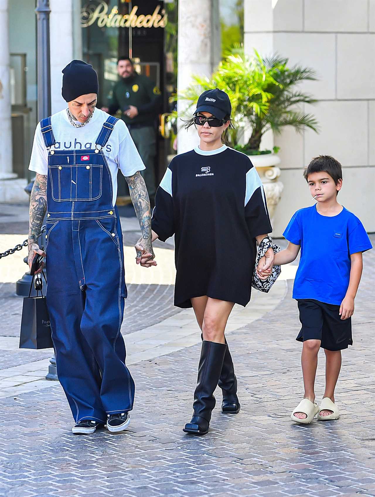 Kourtney Kardashian drowns her frame in baggy T-shirt on day out with Travis Barker and Reign, 7, amid pregnancy rumors