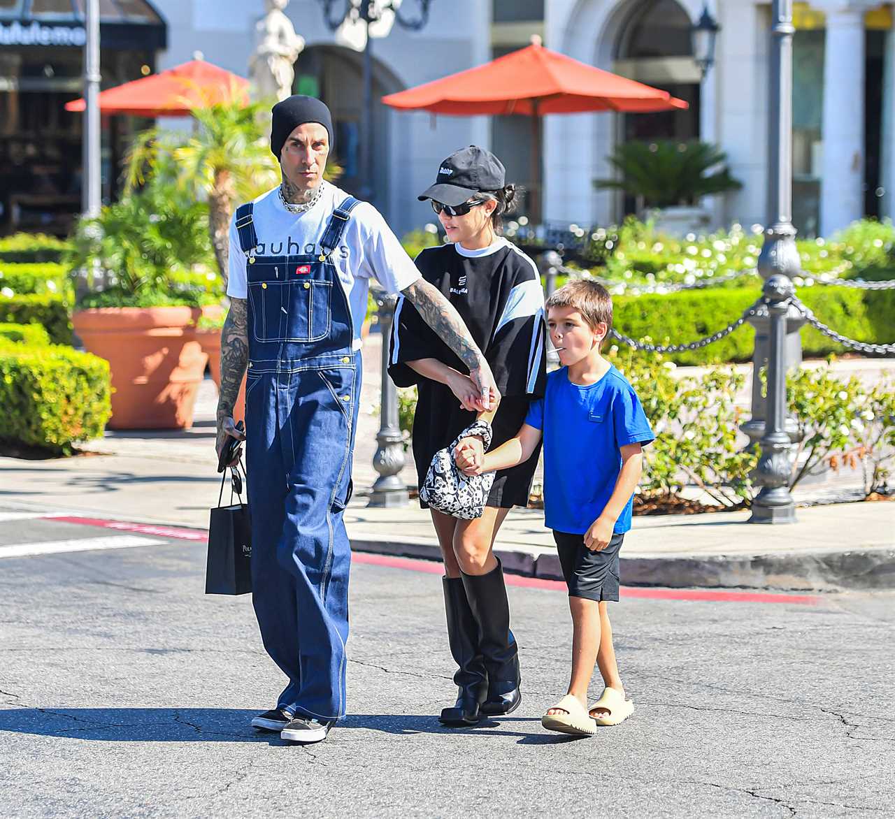 Kourtney Kardashian drowns her frame in baggy T-shirt on day out with Travis Barker and Reign, 7, amid pregnancy rumors