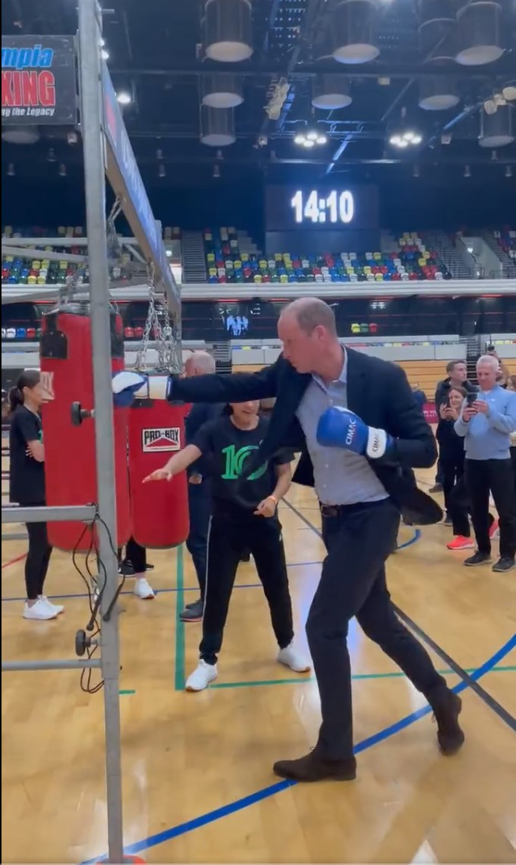 Prince William shows off his right royal hook in charity boxing session while wearing suit