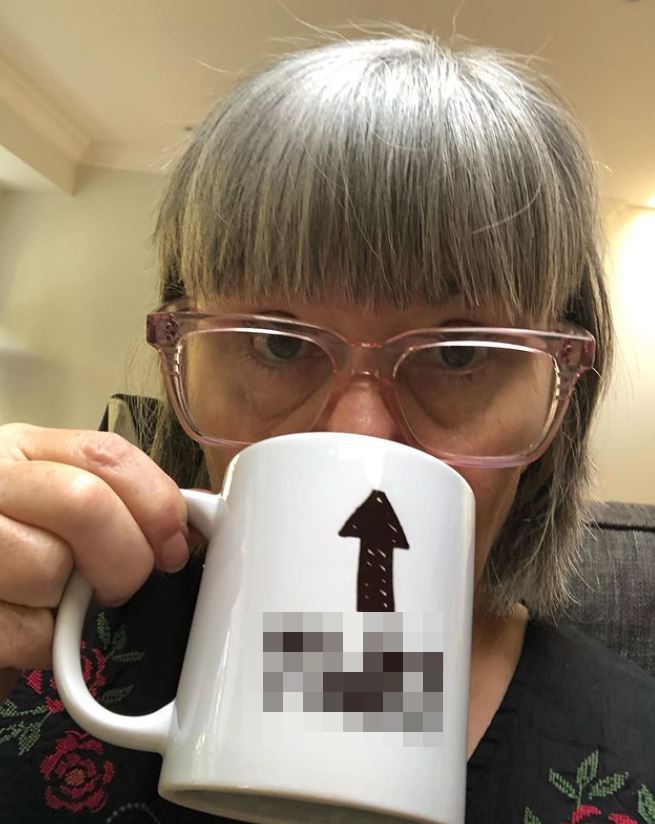 Dawn French is unrecognisable with grey fringe as she sips from rude mug