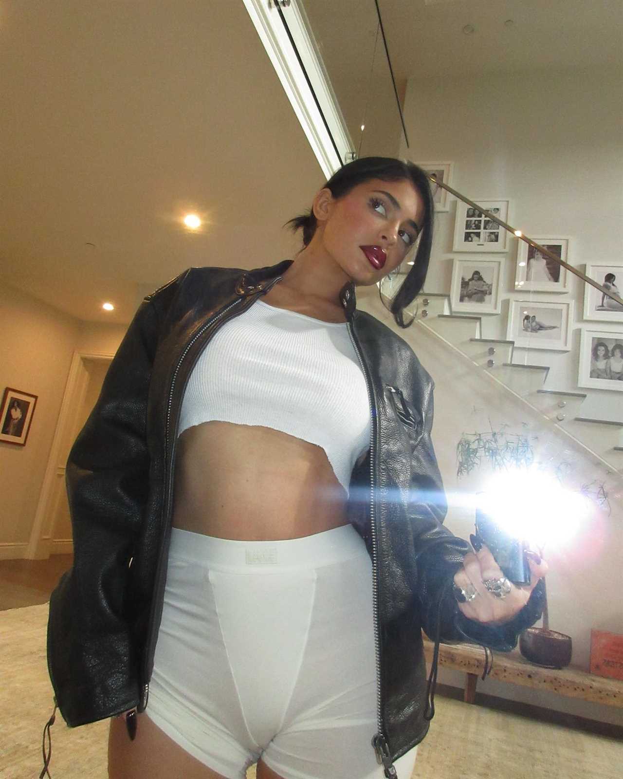 Kylie Jenner shows off her tight tummy in just underwear and see-through tank top after welcoming baby son