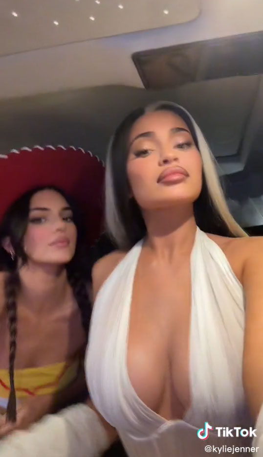 Kylie Jenner shows off major cleavage & her famous curves in a very low-cut top for new Halloween video