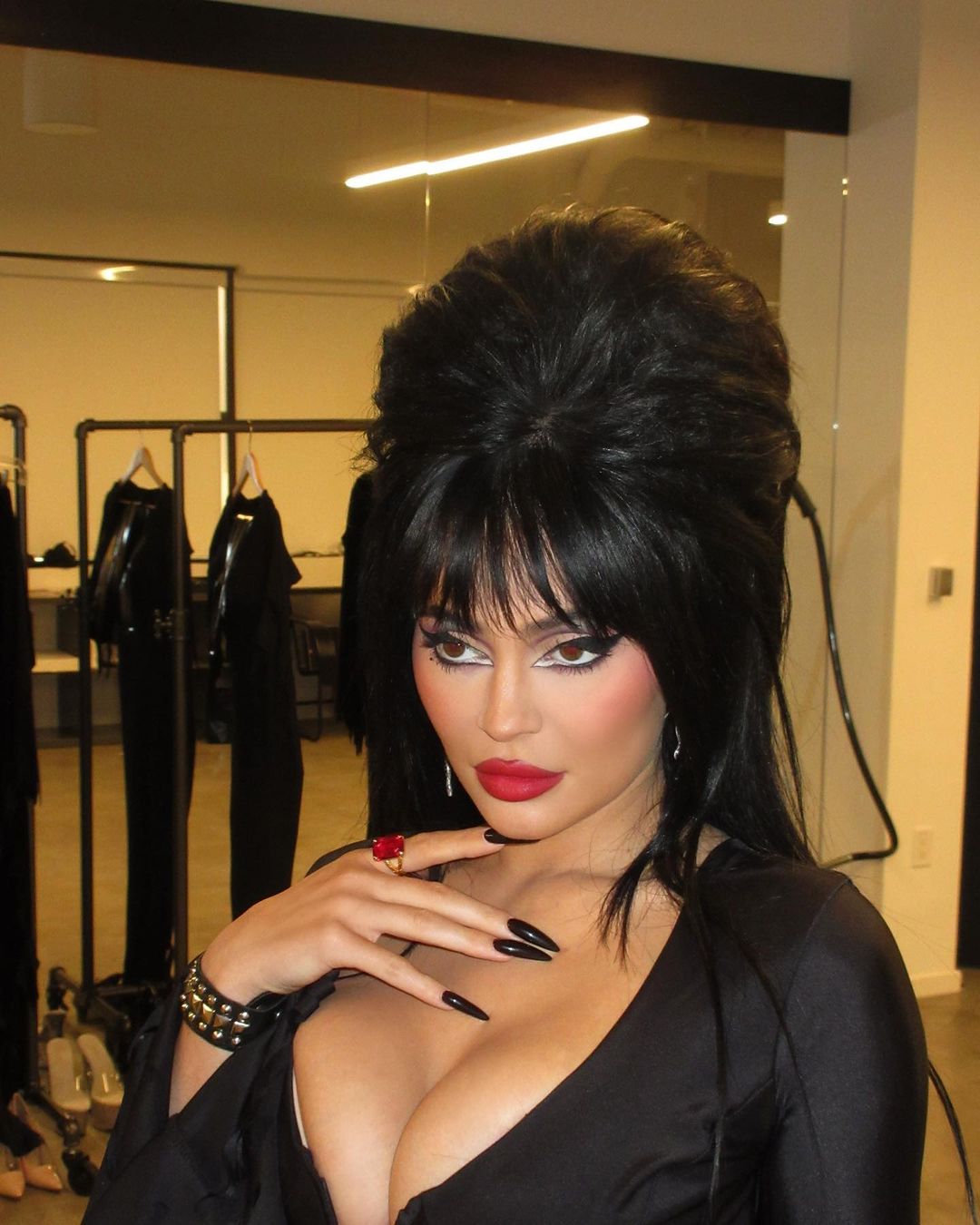 Kylie Jenner almost busts out of plunging tight dress as star channels Elvira in raunchiest Halloween video yet